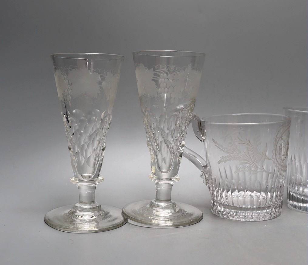 A set of four etched glass flutes, a similar tumbler with an aristocratic crest and mug, and, Flutes 25cms high.